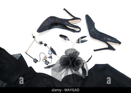 Halloween party female outfit collection accessories black on white background, shoes, cloth with skulls, hat, jewelry, make up, bag. Flat lay, top vi Stock Photo