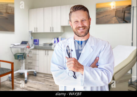 Caucasian Male Doctor Standing In Office. Stock Photo