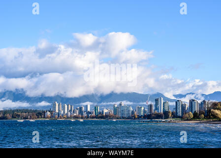 Skyline of condominiums in the West End of Vancouver, British Columbia, Canada, viewed from across bay with fog and clouds lifting. Stock Photo