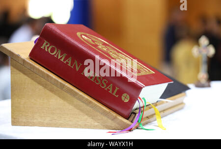 A close up image of the catholic religious book the Roman Missal used at Mass and liturgy by the priest at the alter. Objects of prayer and faith Stock Photo