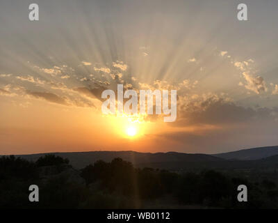 Sunset with clouds and rays Stock Photo