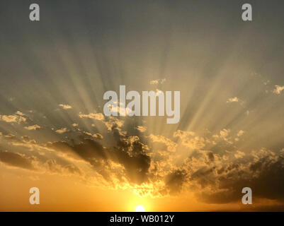 Sunset with clouds and rays Stock Photo