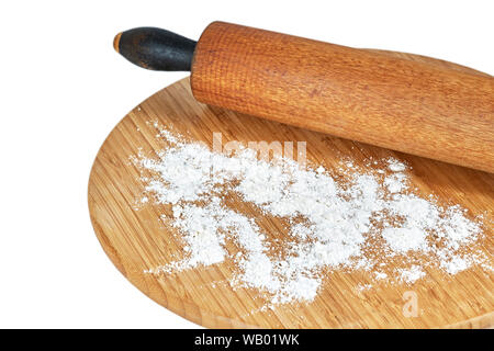 A wooden rolling pin on a bamboo cutting board with white flour on the board isolated on white Stock Photo