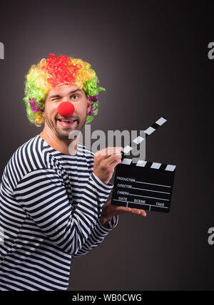 Funny clown with clipper box. Studion shot. Stock Photo