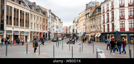 Panoramic view of shopping and sightseeing people along the Rue Esquermoise and Place du General de Gaulle with shops. Lille, France. Stock Photo