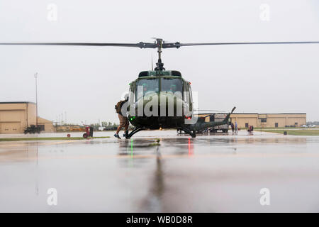 Members of the 54th Helicopter Squadron prepare to take off during the 5th Bombardment Group 100th-year anniversary open house at Minot Air Force Base, North Dakota, Aug. 17, 2019. The event included demonstrations from the 5th Security Forces Squadron K-9 unit, 54th HS and 5th Civil Engineer Squadron explosive ordinance disposal team. (U.S. Air Force photo by Senior Airman Jonathan McElderry) Stock Photo