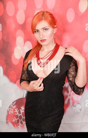pretty stylish girl in red coral jewelry posing on red background Stock Photo