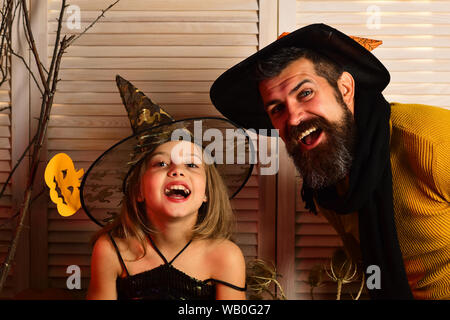 Small girl and father happy smiling on halloween. Happy family celebrate halloween. Happy father and small girl enjoy halloween party. We all go a Stock Photo