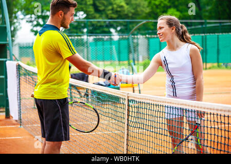 Tennis players shake hands after match. Stock Photo