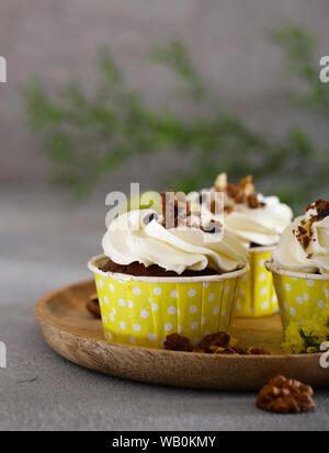 cream cupcakes with walnuts for dessert Stock Photo