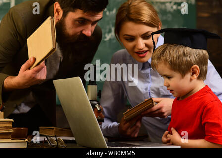 Student writing composition for annual exams preparation, Lecturer discussing architectural issues with students during workshop, Tutor should believe Stock Photo