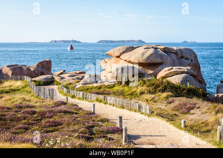 View over the granite blocks along the GR34 coastal path, called the 'sentier des douaniers', on the Pink Granite Coast in northern Brittany, France. Stock Photo
