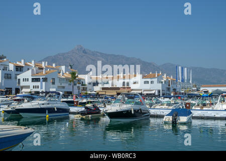 Puerto Banus, Marbella, Spain. Waterfront shops and apartments surround the marina of this busy and popular tourist location. Stock Photo