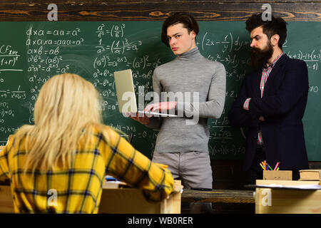 University studying friends studying and reading a books in classroom. Teachers reputation is gold. Students build positive relationships with their t Stock Photo