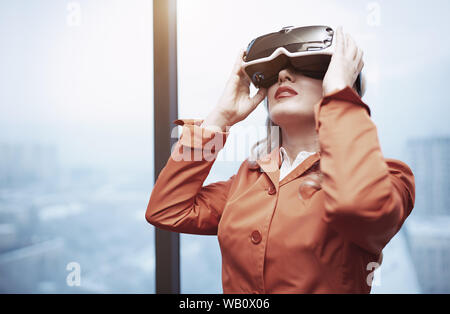 Woman at office wearing Virtual reality headset Stock Photo