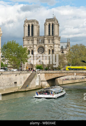 River cruise boat passing the Notre-Dame Cathedral, Paris, France Stock Photo