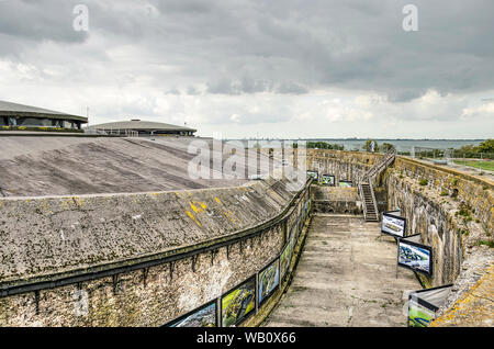 Muiden, The Netherlands, August 21, 2019: view of the fortress on the artificial island of Pampus with two artilery domes and a dry moat, and the city Stock Photo