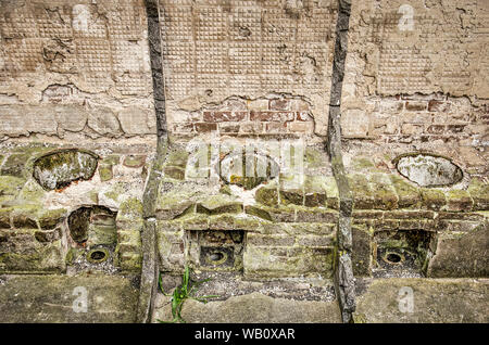 Muiden, The Netherlands, August 21, 2019: remnants of three primitive toilets in the fort of Pampus, Unesco world heritage site and part of the Amster Stock Photo