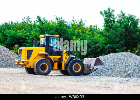 Unload bulk cargo with of the cargo railway platform in the mining quarry Stock Photo