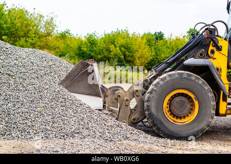 Unload bulk cargo with of the cargo railway platform in the mining quarry Stock Photo