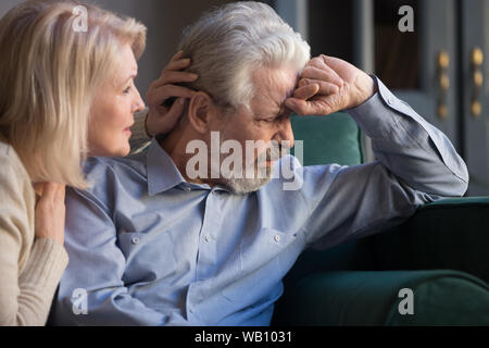 Loving worried middle aged wife comforting apologizing sad senior husband Stock Photo