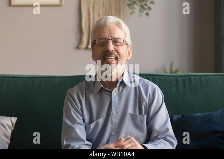 Happy senior retired man looking talking to camera webcam Stock Photo