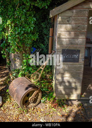 Shed with Welcome sign and traditional garden roller, Nunnington Hall, North Yorkshire, UK. Stock Photo