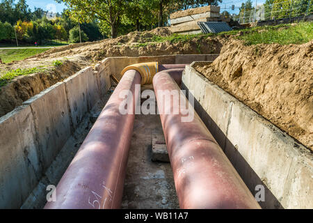 Underground pipe installation. Steel, giant. Laying or replacement of underground pipes. Installation of underground pipes. Utility infrastructure Stock Photo