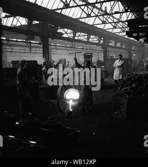 Iron foundry workers pouring molten metal Britain 1964 Stock Photo