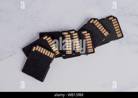 Multiple SD Cards in pile on table. Storage for professional photography. Stock Photo