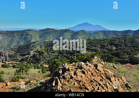 Landscape in the Teno mountains on the Canary Island of Tenerife, in the background the volcano Teide, in front of it mountain ranges with crippled la Stock Photo