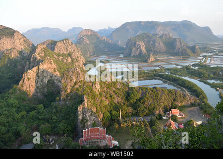 The limestone mountains with wetland and mangrove forest , Buddhist temple in the valley in view from Public attractions Khao Daeng  Viewpoint Stock Photo