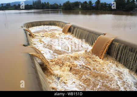 Turbid water in the dam overflows into the spillway  , Thailand Stock Photo