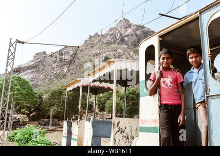 Khandoli Park, Giridih, Jharkhand, India May 2018 - Kids enjoying an Amusement Park Toy Train ride while nicely posing to the photographer. Kid Poses Stock Photo