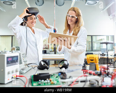 Female technicians working with tablet and vr glasses Stock Photo