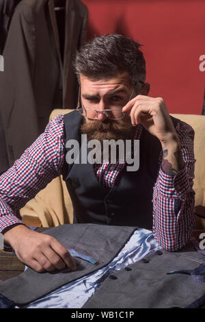In touch with suppliers. business dress code. Handmade. sewing mechanization. Bearded man tailor sewing jacket. retro and modern tailoring workshop. s Stock Photo