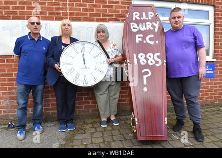 Bury fans deliver a symbolic coffin reading 'R.I.P Bury F.C. 1885 ?' and clock at Gigg Lane, home of Bury FC. Stock Photo