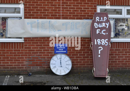 Bury fans deliver a symbolic coffin reading 'R.I.P Bury F.C. 1885 ?' and clock at Gigg Lane, home of Bury FC. Stock Photo