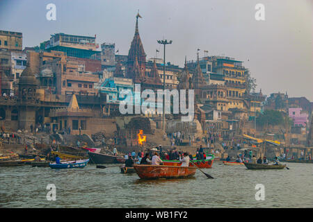 Sacred funeral pyres on the bank of the River Ganges, Varanasi, India Stock Photo