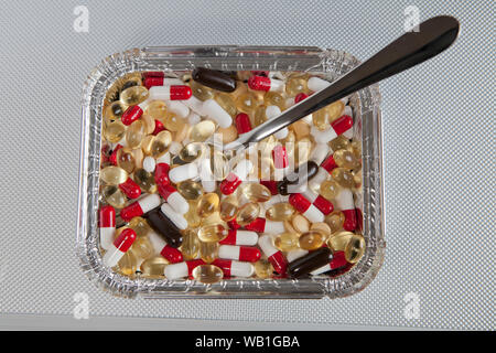 A selection of different pills in a fast food container. Stock Photo