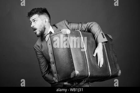 Theft of century. Thief run away with heavy suitcase. Delivery service. Travel and baggage concept. Hipster traveler with baggage. Baggage insurance. Stock Photo