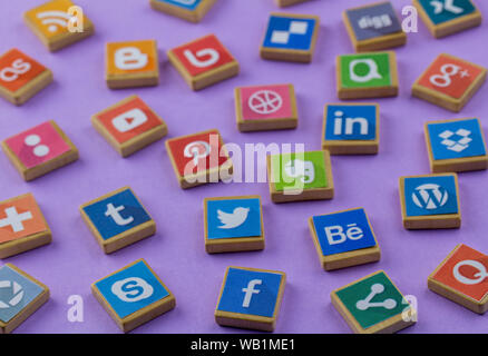 QUEENSTOWN, SOUTH AFRICA -  6 JULY 2019 -Social media background with social media logos on wooden game blocks on lilac background - Social networking Stock Photo