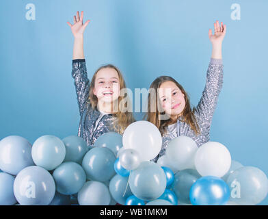 Sisters organize home party. Having fun concept. Balloon theme party. Girls little siblings near air balloons. Birthday party. Happiness and cheerful moments. Carefree childhood. Start this party. Stock Photo