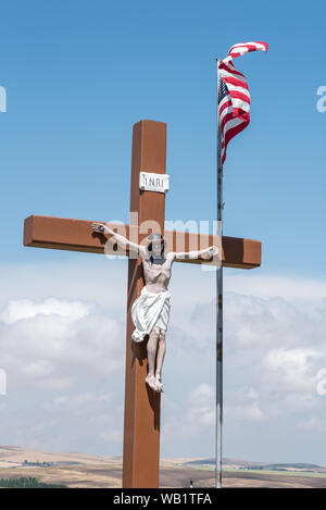 Jesus on cross and American flag in a Catholic cemetery in Cottonwood, Idaho. Stock Photo