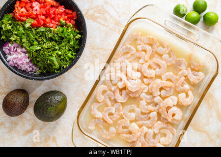 Ceviche, also known as cebiche, seviche and sebiche. Making shrimp ceviche and the ingredients needed for cooking this Latin American seafood dish Stock Photo