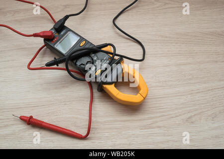 Clamp meter digital on wooden background. Stock Photo