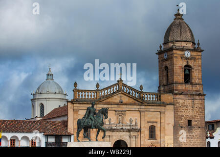 TUNJA, COLOMBIA - AUGUST, 2019:  Equestrian monument to the Liberator Simon Bolivar with the Basilica of St. James the Apostle on background at the Bo Stock Photo