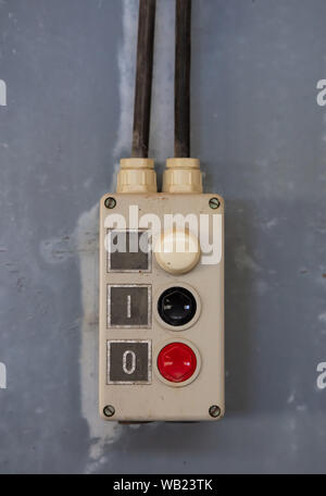 Start, stop concept. Push buttons, red and black color switch, old retro industrial control panel closeup view Stock Photo