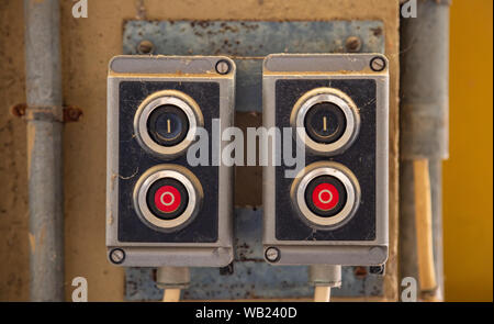Start, stop concept. Push buttons, red and black color switches old retro industrial control panel closeup view Stock Photo