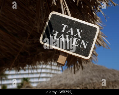 Tax haven sign on wooden plate. Stock Photo